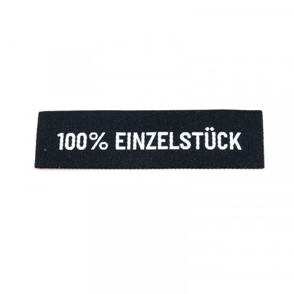 Vævet etiket "100% Einzelstück" 59 x 15 mm